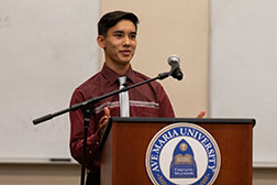 Student speaking at podium. Link to Gifts by Will